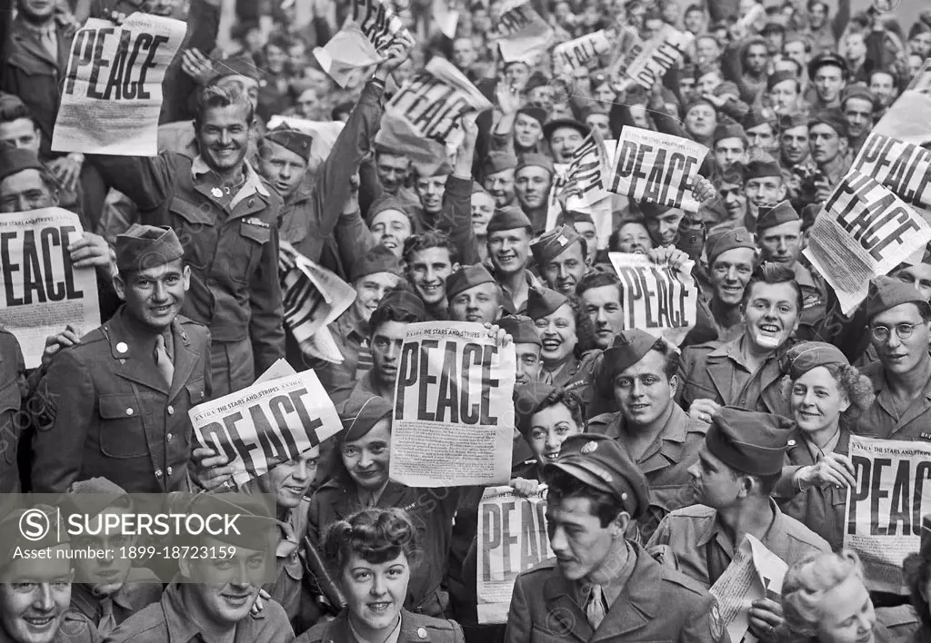 VE Day - Soldiers hold up the Stars and Stripes newspaper in celebration of the end of WWII in Europe May 8, 1945.