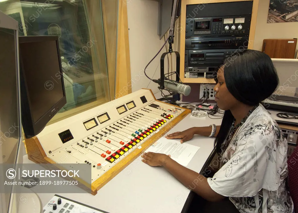 An African-American senior from Calvert High School in Calvert Texas has an opportunity to view the radio studio in the United States Department of Agriculture Creative Media and Broadcast Center from the control booth while on a Career Opportunity tour of USDA as part of a senior trip sponsored by the Farm Service Agency “Ag in the Classroom” program. 