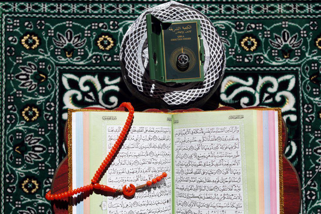 Open Quran on Muslim prayer mat at home. France. (Photo by: Fred de Noyelle/Godong/UIG)
