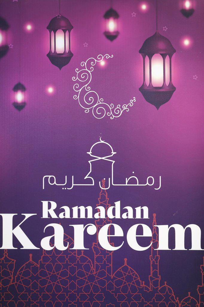 Ramadan kareem arabic calligraphy greeting with crescent and lanterns. Dubai. United Arab Emirates.