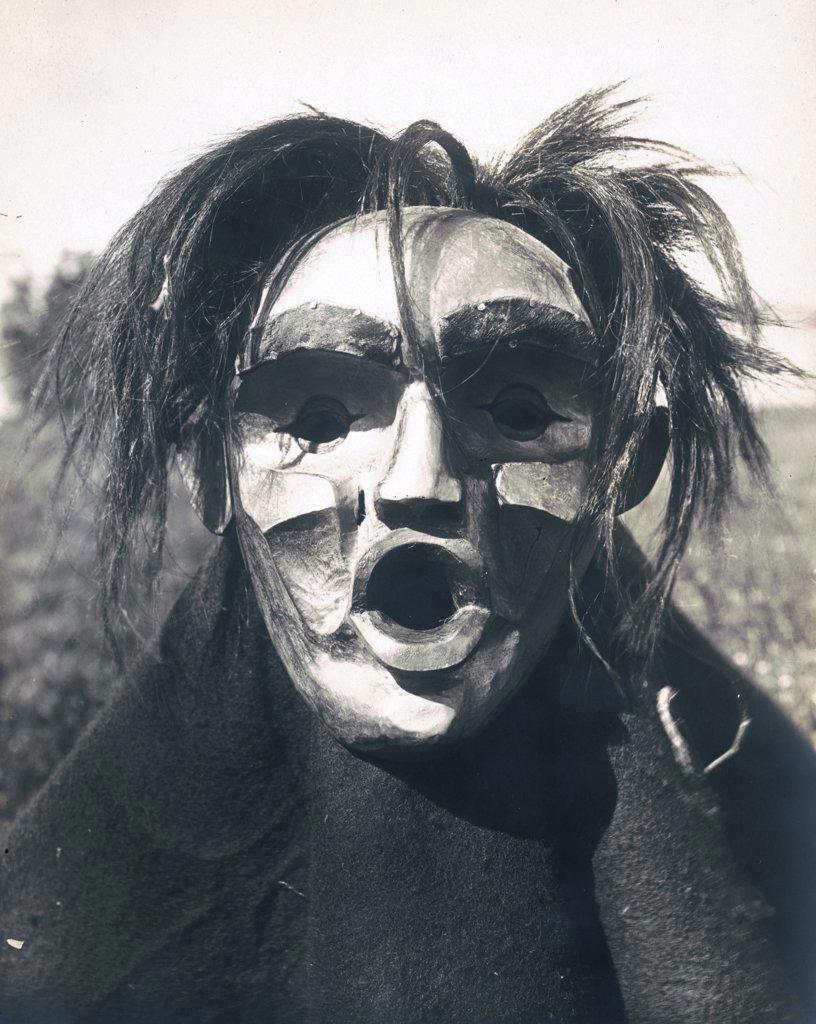 Edward S. Curits Native American Indians -  Person wearing Mask of Tsunukwalahl, a mythical being, used during the Winter Dance circa 1914.