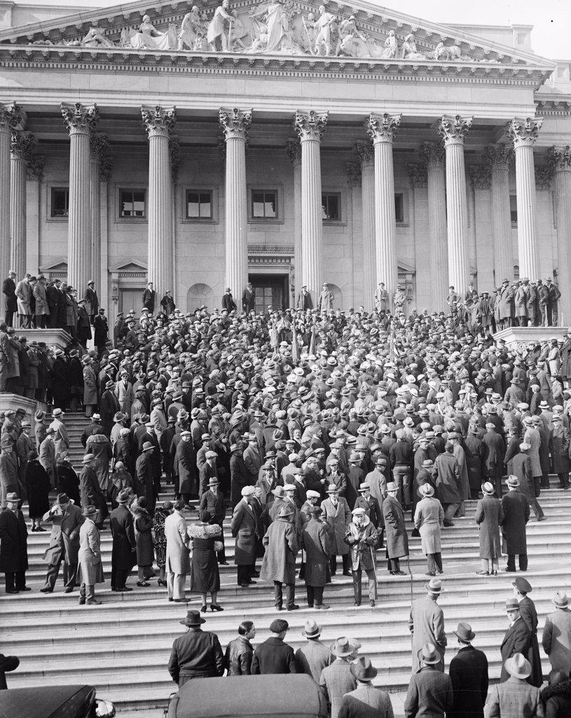 Protesting Congress' delay in considering the soldiers' cash bonus proposal, scores of Washington veterans paraded to the Capitol in a demonstration to seek immediate action circa 1931.