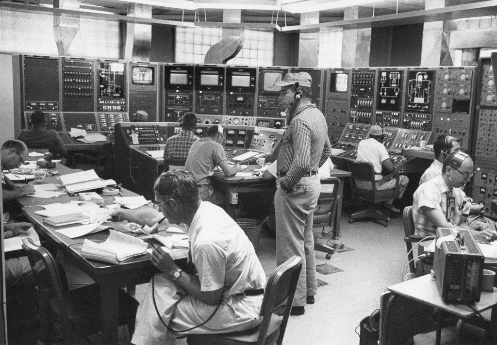 In a large room lined with instrument panels, scientists from Los Alamos Scientific Laboratory operate the Kiwi-A3 nuclear rocket reactor remotely to research the potential of nuclear space propulsion, Los Alamos, NM, 10/19/1960.