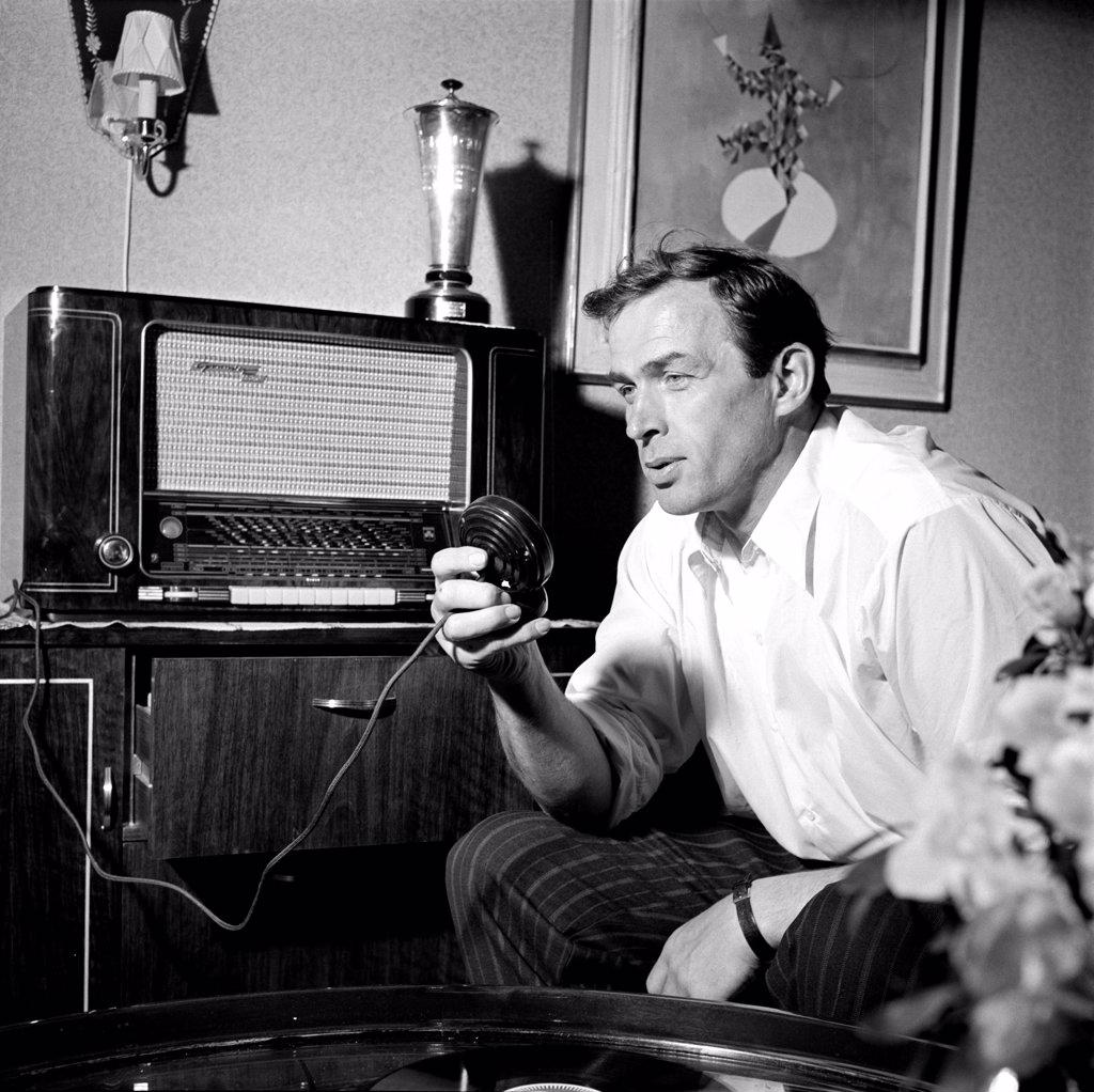 Finland History -  Man at home in Helsinki talking or singing in a microphone ca. 1954. 