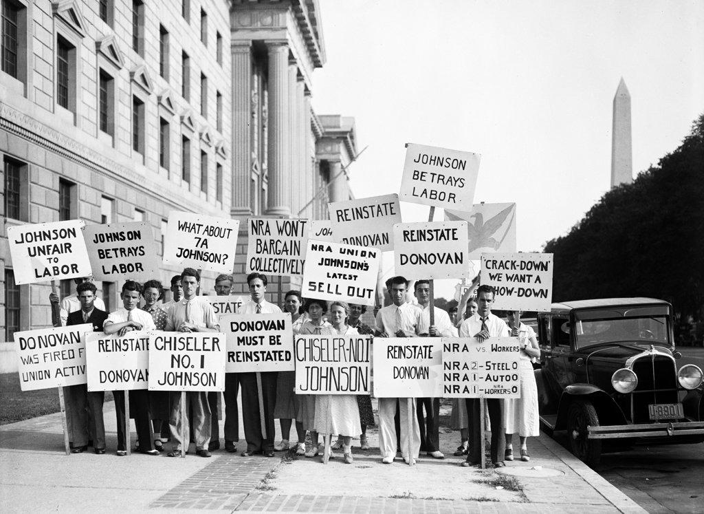 Protesters with signs: 'Johnson unfair to labor,' 'Reinstate Donovan,'  June 1934. 