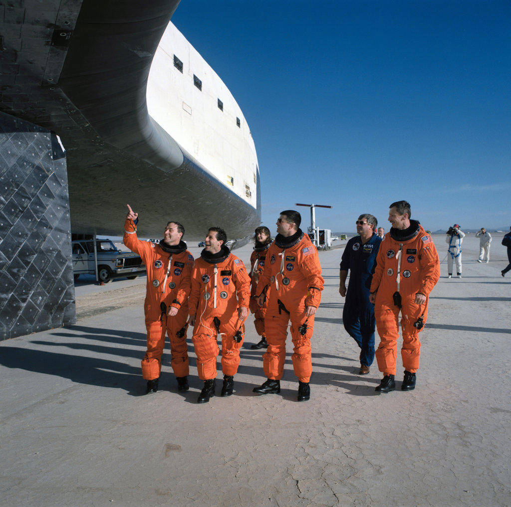STS-37 crewmembers inspect the underside of Atlantis, OV-104, at EAFB. 
