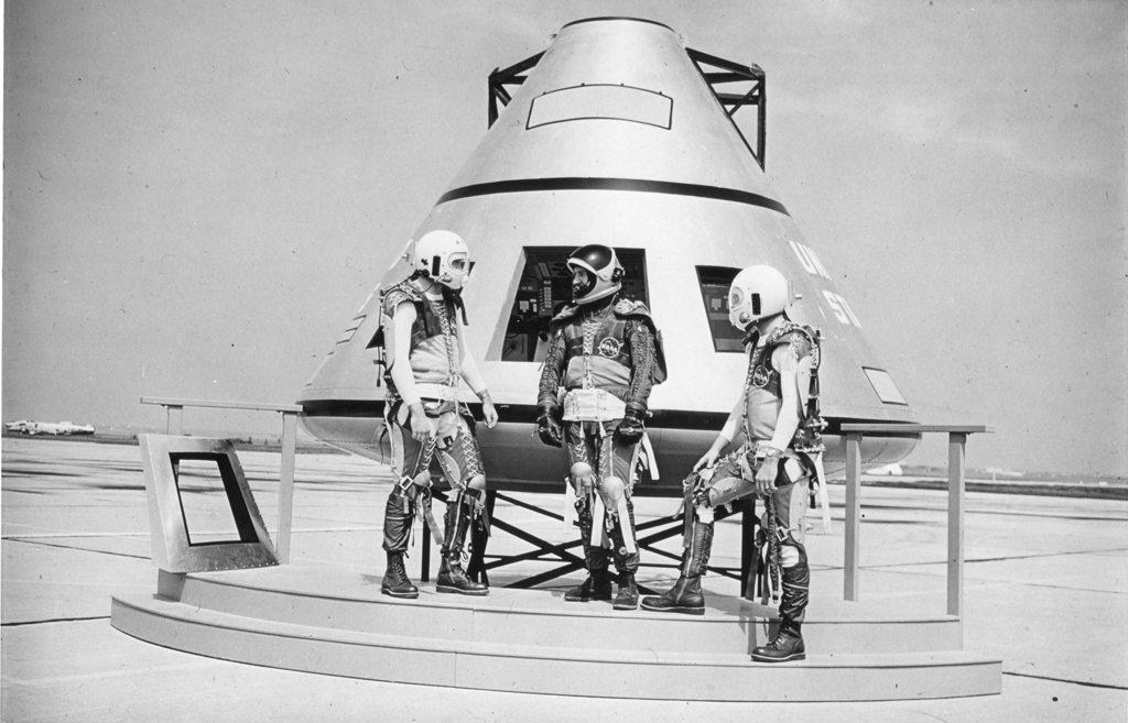 Three US Astronauts in full space attire, pose beside a model of the Apollo capsule designed to take men to the moon. Unmanned flights of the three-man capsule, scheduled to follow Gemini tests, will mark the beginning of the Apollo Program which will land men on the moon before the end of the decade, Cape Canaveral, FL, 1962. (Photo by NASA/GG Vintage Images)