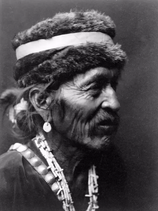 Edward S. Curits Native American Indians - Navajo Indian Man wearing fur cap circa 1905.