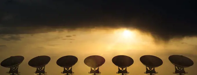 Large radio telescopes searching the skies at sunrise on a clear day 3D Rendering