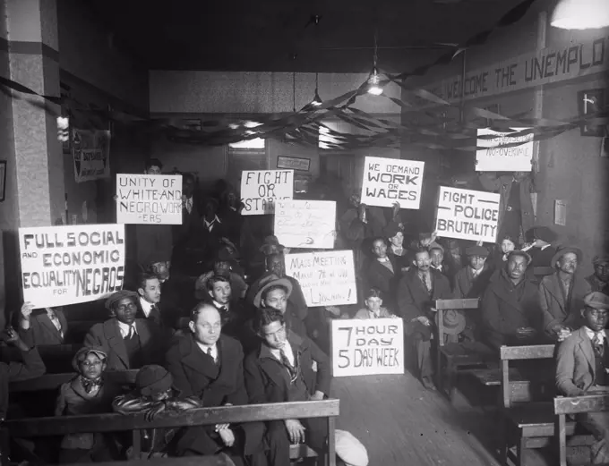 Labor protesters with signs: 'Full Social and Economic Equality for Negros,' 'Unity of White-and-Negro Workers,' etc. circa 1930.