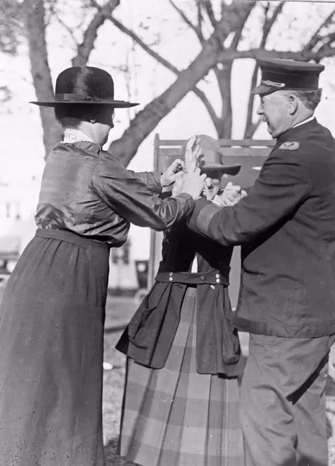 Training a policewoman--Inspector Cross and Miss Clark, veteran policewoman, are shown demonstrating the correct way to handcuff a prisoner ca. 1909.