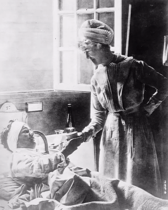 Nurse and patient ca.  between 1910 and 1935.