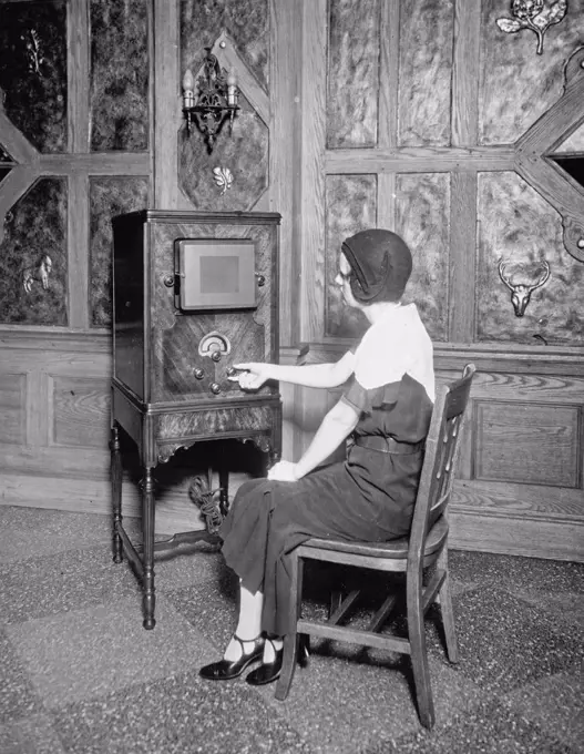Woman with radio between 1910 and 1935.