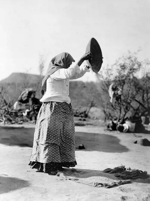 Edward S. Curtis Native American Indians - Papago Indian woman cleaning wheat (Winnowing wheat) ca. 1908. 