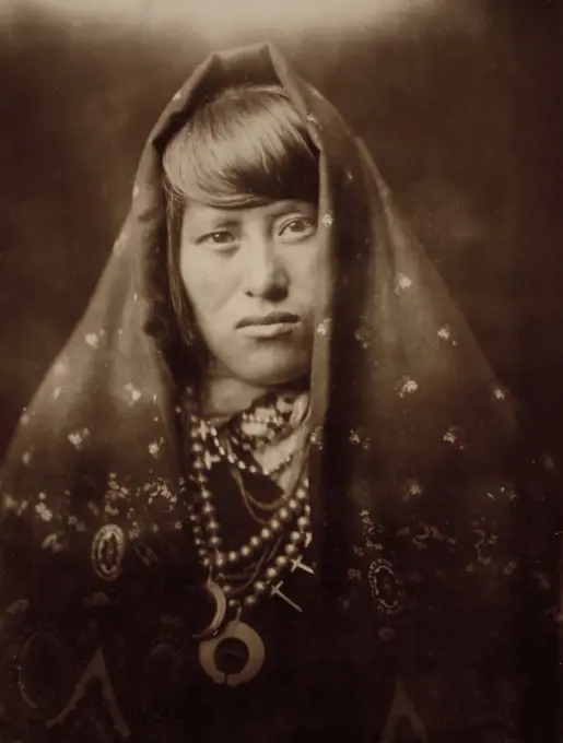 Edward S. Curits Native American Indians - Head-and-shoulders portrait of an Acoma woman, facing front, with head covered and wearing jewelry ca. 1905. 