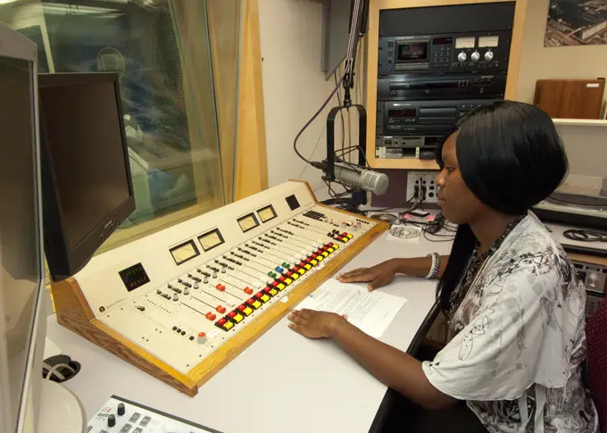 An African-American senior from Calvert High School in Calvert Texas has an opportunity to view the radio studio in the United States Department of Agriculture Creative Media and Broadcast Center from the control booth while on a Career Opportunity tour of USDA as part of a senior trip sponsored by the Farm Service Agency “Ag in the Classroom” program. 