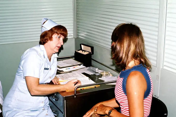 1976 - A nurse screens a woman prior to her admittance as a patient at the Hospital. 