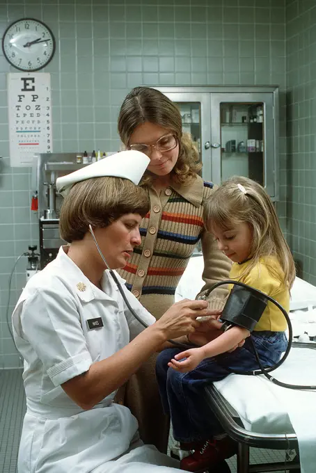 1977 - A nurse takes a child's blood pressure. 