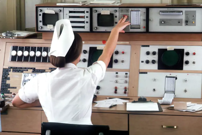 1973 - a nurse checks cardiac monitors. 