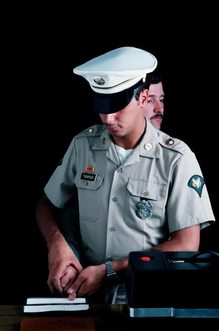 1976 - A US Army military policeman takes fingerprints. 