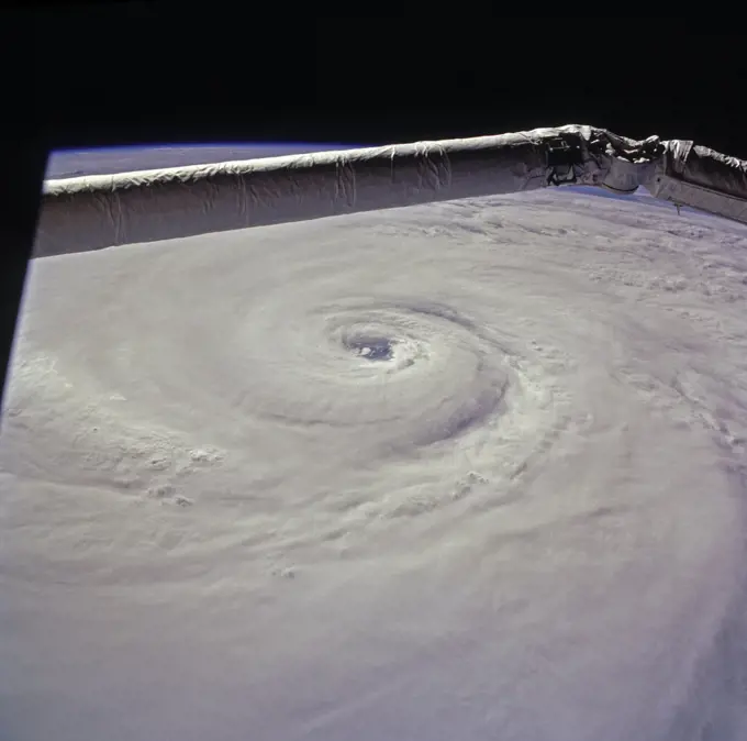 (15 August 1997) --- This view of supertyphoon Winnie was taken on August 15, 1997, as the storm swirled about 400 miles south of the southern tip of Japan.  Sustained winds were 105 knots, gusting to 130 knots.  This photo was shot on the Space Shuttle Discovery's twenty-third flight, as it glided by 170 miles above the sea surface on Orbit 123.  On one pass the Discovery flew right over the eye; the commander commented that the eye was so large that it completely filled the window.  The robotic arm crosses the top of the view.  The cloud mass associated with Winnie covered thousands of square miles as this storm grew to supertyphoon status in the previous days, and raked across the Marianas Islands.  A few days after this shot was taken, Winnie ploughed ashore on the coast of China, a bit south of the major metropolis of Shanghai, reportedly killing at least 100 people.. 