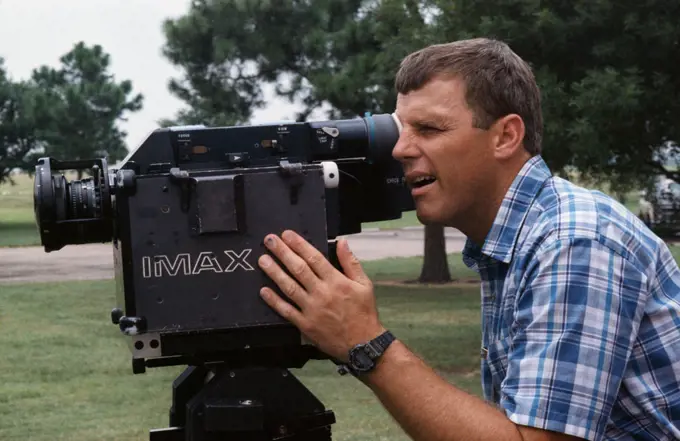 (20 July 1991) --- Astronaut Stephen S. Oswald, STS-42 pilot, uses the IMAX camera system (ICS) during training session held at Johnson Space Center's (JSC) Manned Space Flight Exhibit Complex Bldg 90 (Rocket Park). Oswald squints as he looks through the ICS eyepiece.. 