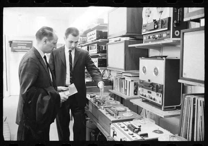 Salesman in a tape recorder showroom show potential customer various models and options, no location, 3/7/1964. (Photo by Warren K Leffler/US News & World Report Collection/GG Vintage Images/UIG)