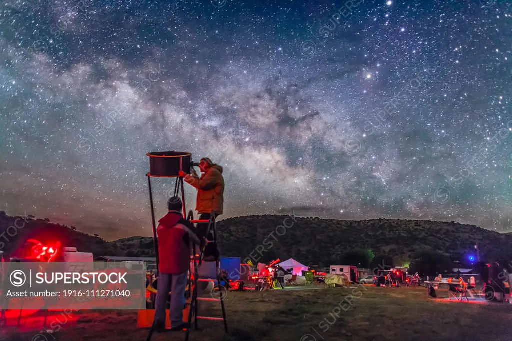 Observers at the Texas Star Party explore the wonders of the deep sky under the rising Milky Way, in May 2015. Sagittarius and Scorpius are in the background, with the centre of the Galaxy rising in the southeast. This is a single 30-second exposure at f/2 with the 24mm lens and Canon 5D MkII at ISO 4000.