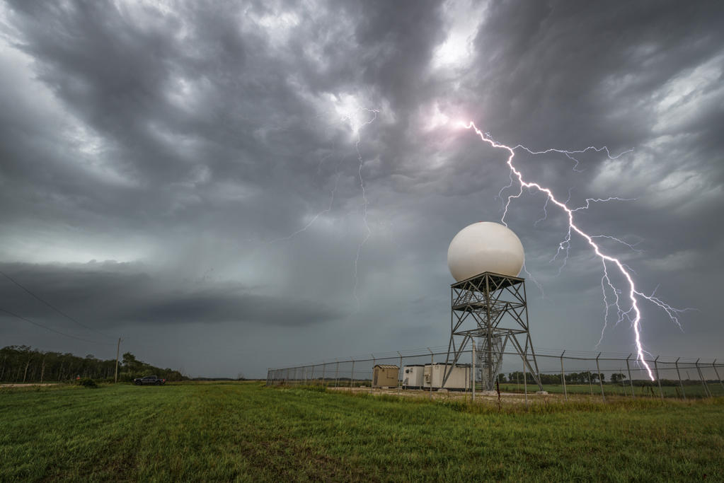 Storm with close range lightning striking near the woodlands radar station in rural Manitoba Canada