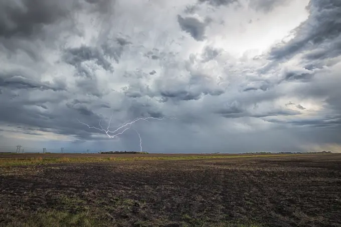 Lightning striking over field in rural southern Manitoba Canada