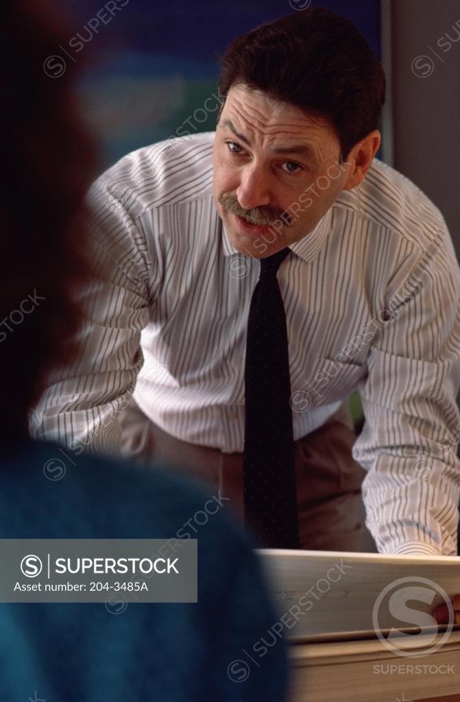 Stock Photo: 204-3485A Business man talking to woman in office