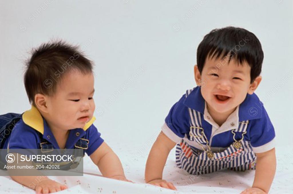 Stock Photo: 204-4202E Two baby boys playing