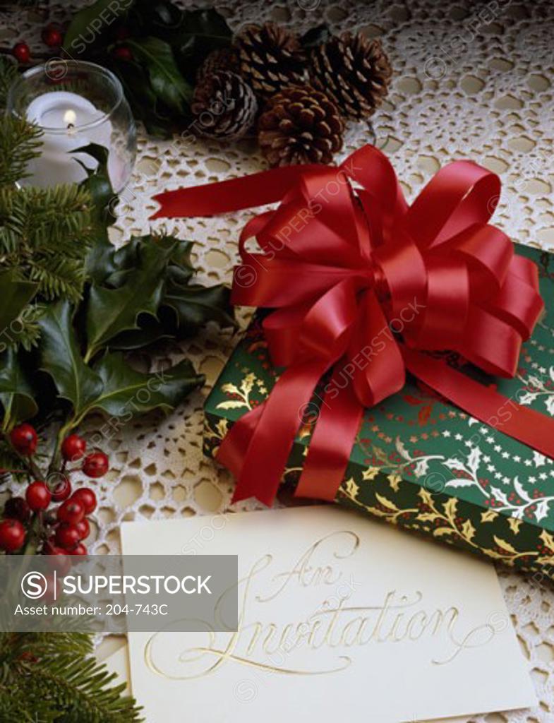 Stock Photo: 204-743C Close-up of a Christmas present with an invitation
