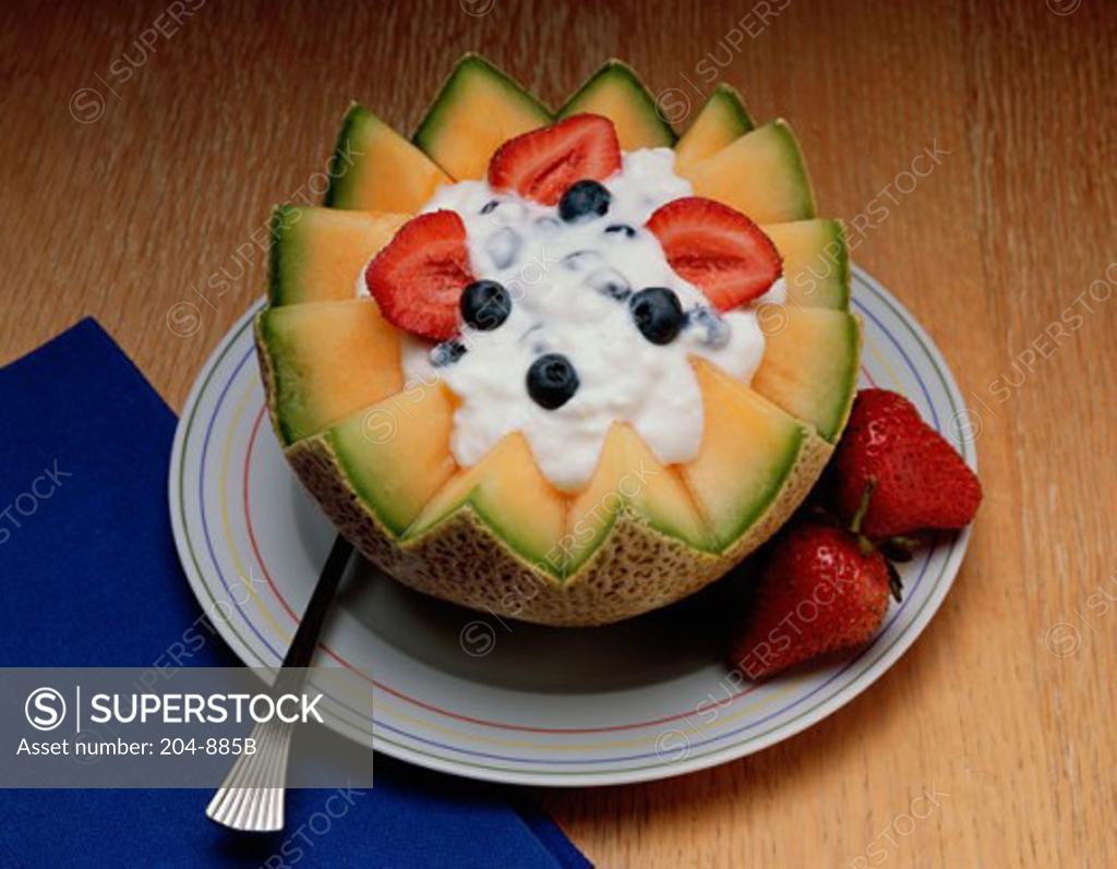Stock Photo: 204-885B Melon decorated with Strawberries and cream