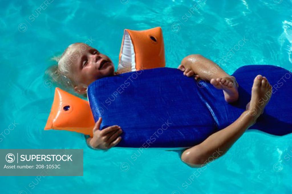 Stock Photo: 208-1053C High angle view of a boy floating on water with a pool raft