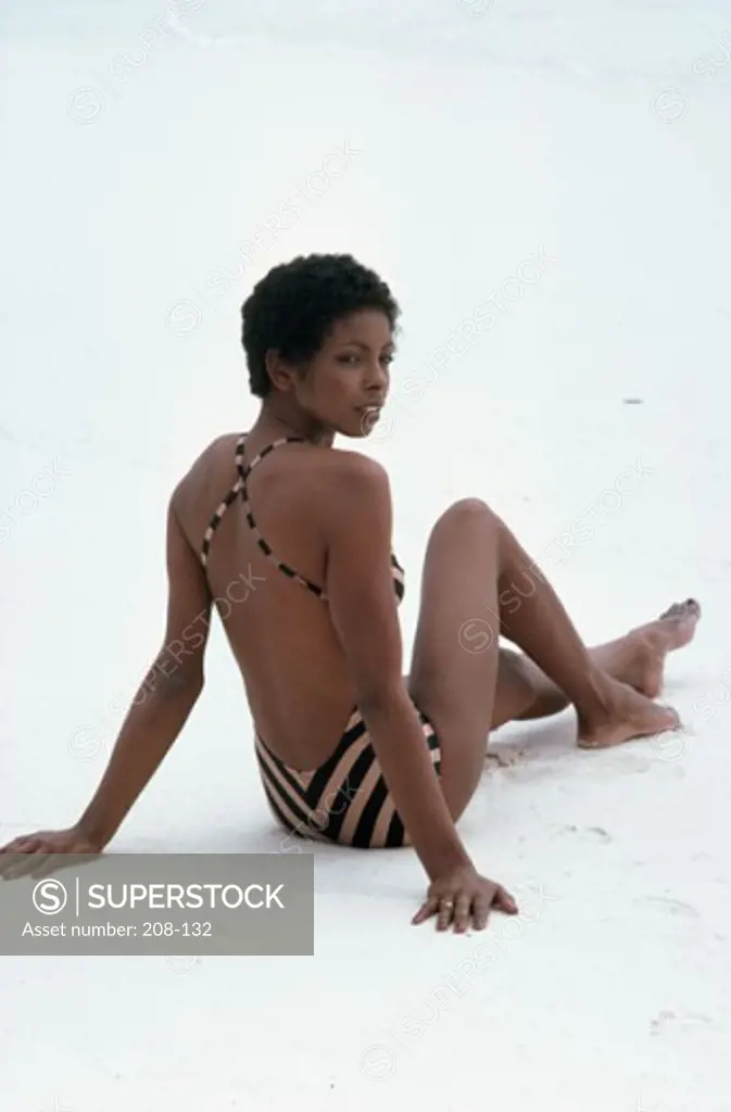 Rear view of a young woman sitting on the beach