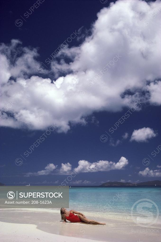 Stock Photo: 208-1623A Young woman sunbathing on the beach
