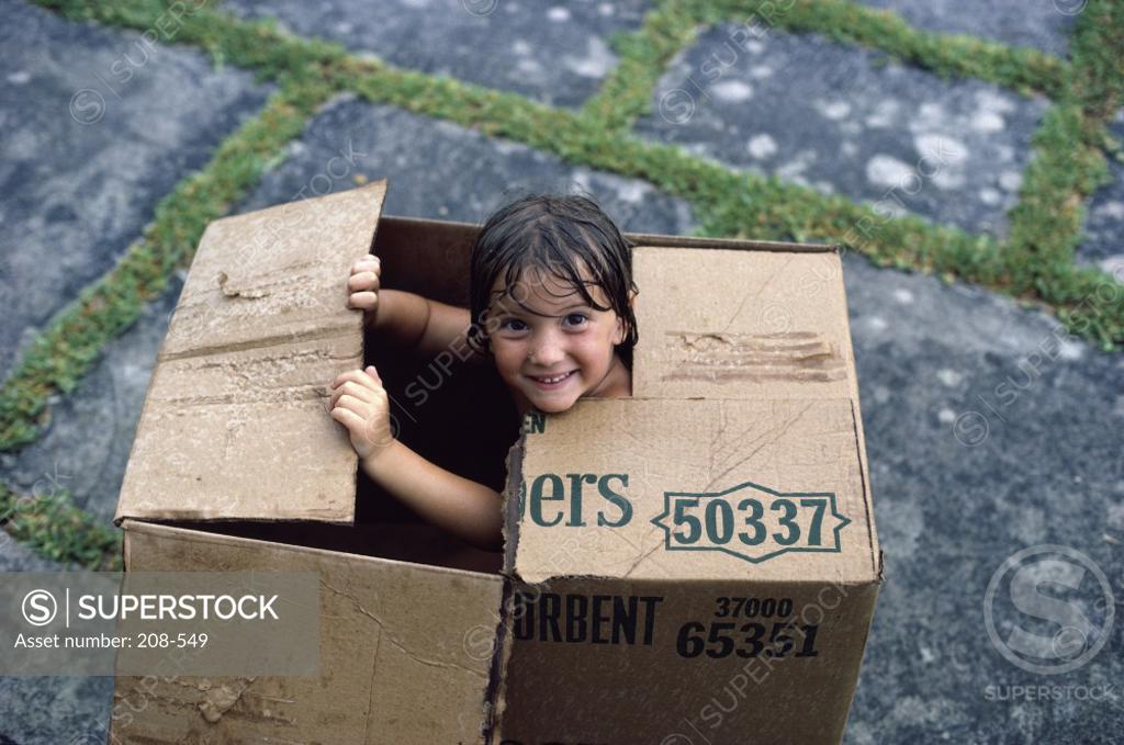Stock Photo: 208-549 High angle view of a girl sitting in a cardboard box