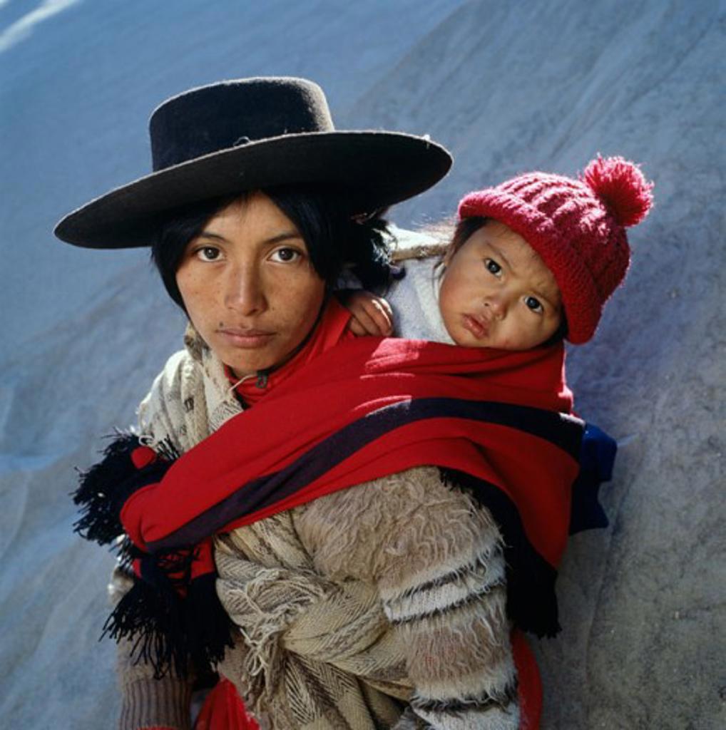 Portrait of a mother carrying her son on her back, Argentina