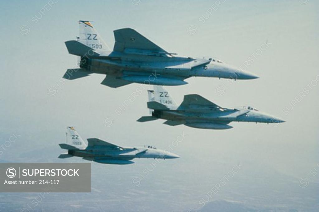 Stock Photo: 214-117 Low angle view of three F-15 Eagle fighter planes flying in formation