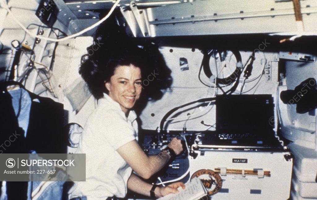 Stock Photo: 227-657 Dr. Bonnie Dunbar Working with Rockwell International's Fluids Experiment Apparatus Aboard Shuttle Columbia, STS-32, Jan. 1990