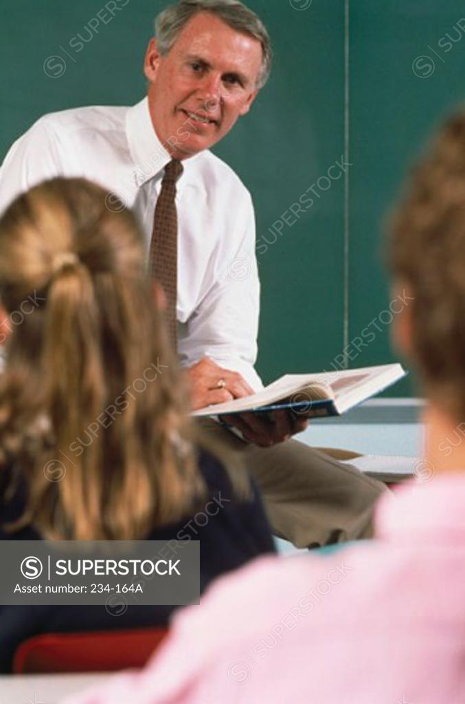 Stock Photo: 234-164A Teacher teaching students in a classroom