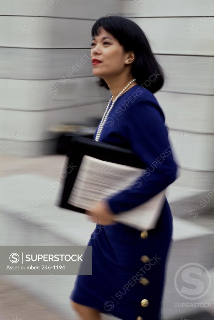 Stock Photo: 246-1194 Businesswoman carrying a portfolio