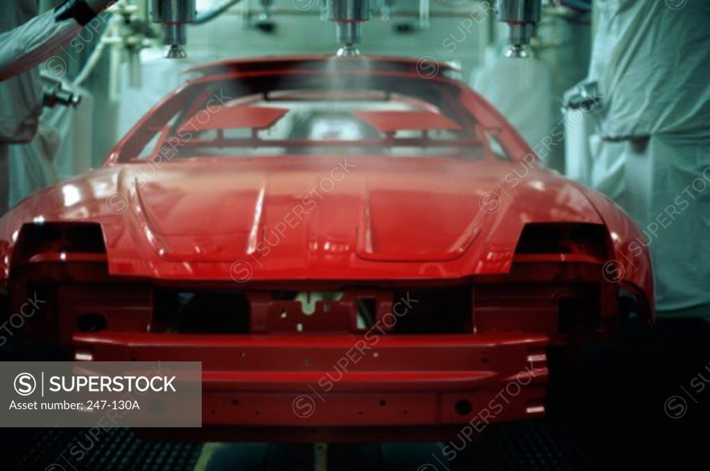 Stock Photo: 247-130A Robotic arms spraying paint on a car body