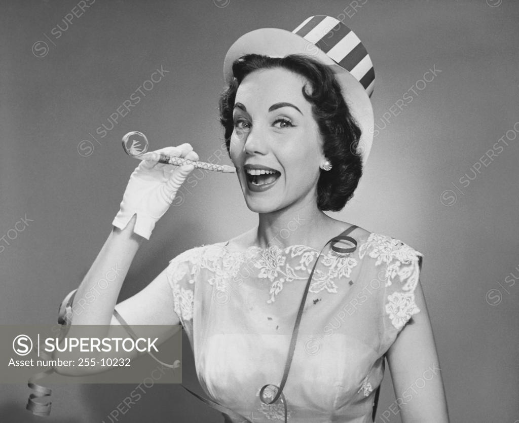 Stock Photo: 255-10232 Close-up of a young woman holding a noisemaker