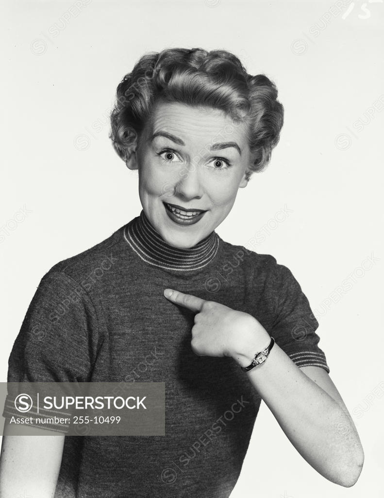 Stock Photo: 255-10499 Portrait of a young woman pointing to herself