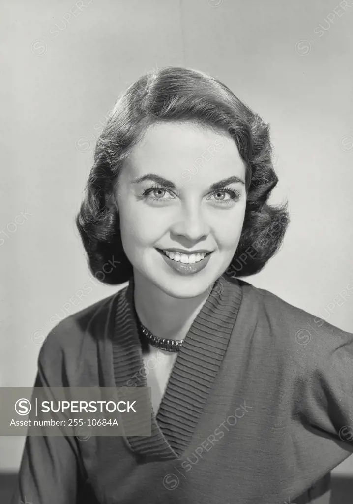 Vintage photograph. Brunette woman smiling at camera