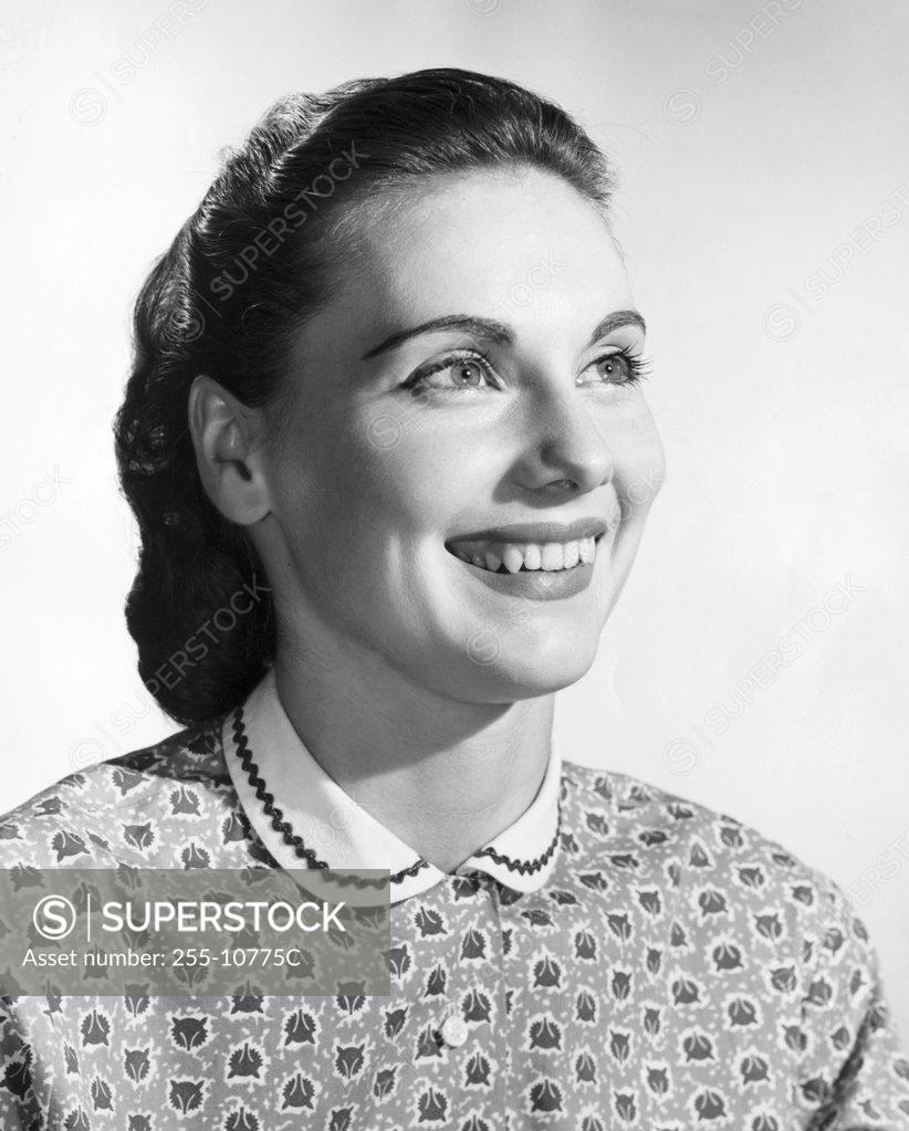 Stock Photo: 255-10775C Studio portrait of mid adult woman smiling