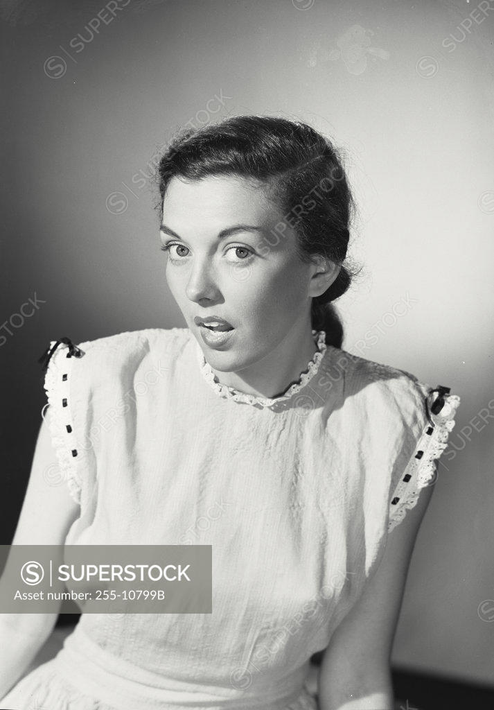 Stock Photo: 255-10799B Portrait of a young woman looking surprised