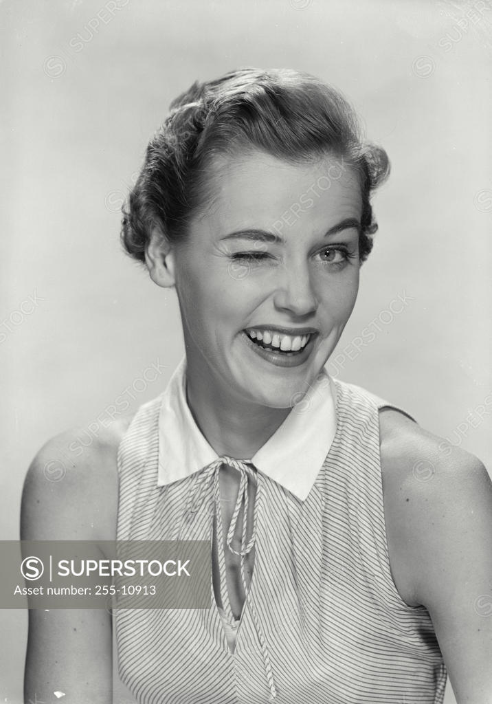 Stock Photo: 255-10913 Portrait of a young woman winking